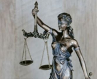 A statue of Lady Justice holding scales, symbolizing legal balance, compliance, and best practices governing telework frameworks.